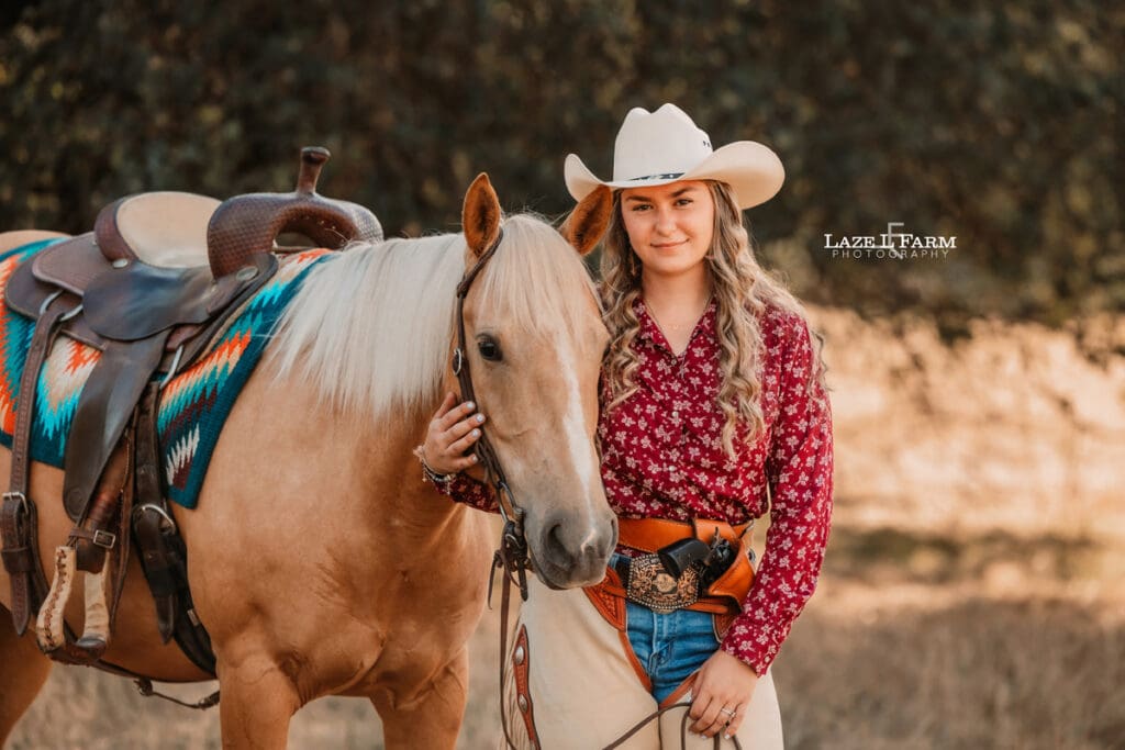 cowgirl standing with her horse