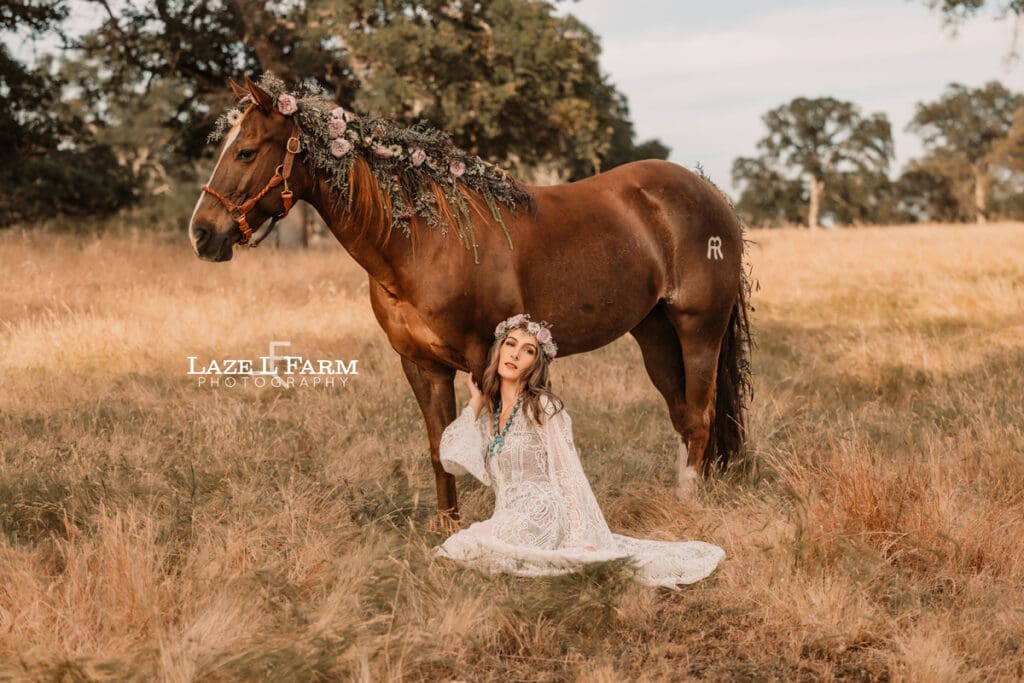 cowgirl with a lacy dress with flowers in her with a horse