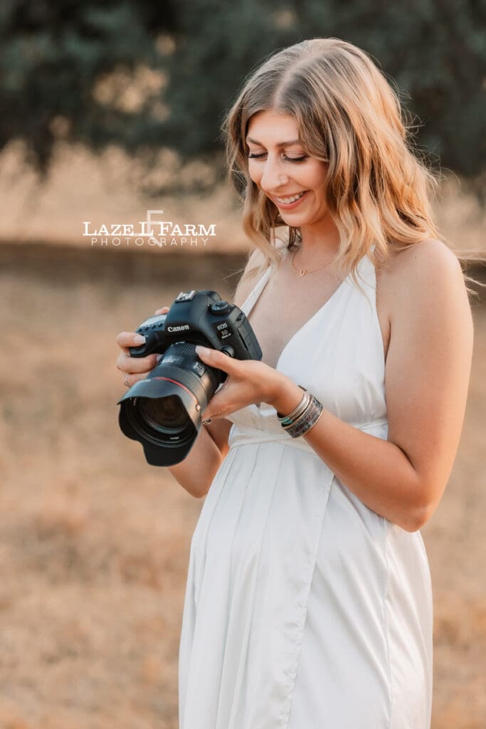 a girl with her camera in a field