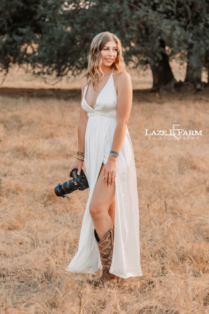a girl with her camera in a field