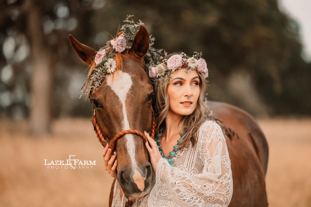 cowgirl with a lacy dress with flowers in her with a horse