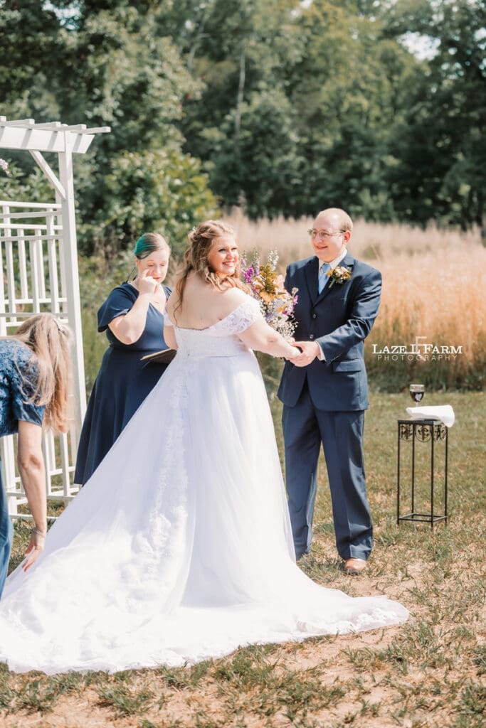Bride and Groom at the altar during their wedding at Woodside Farm in Graham, NC with pictures by Laze L Farm Photography