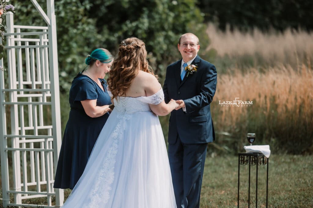 Bride & Groom during their wedding saying their vowels during their wedding at Woodside Farm in Graham, NC with pictures by Laze L Farm Photography