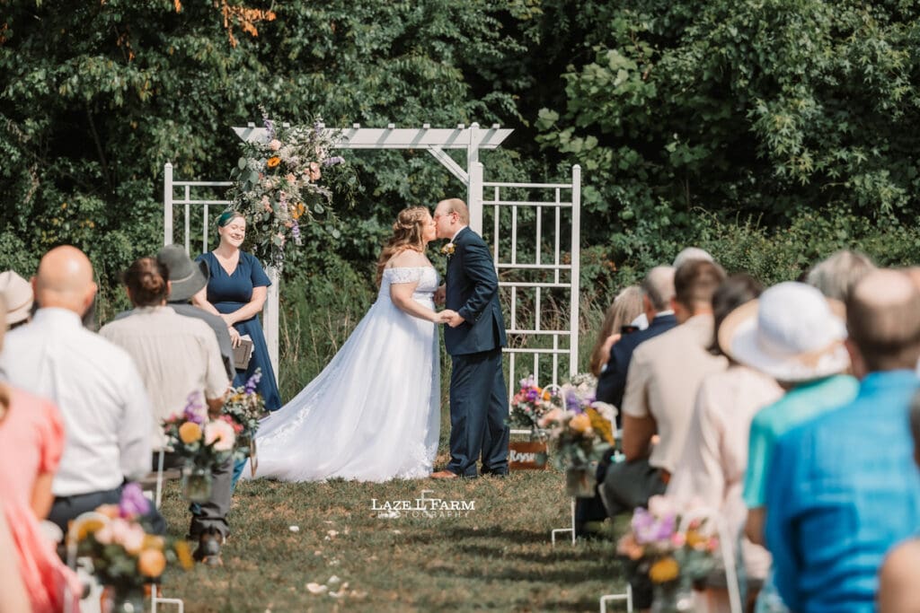 Wedding Couple at the alter on their wedding day at Woodside Farm in Graham, NC with pictures by Laze L Farm Photography