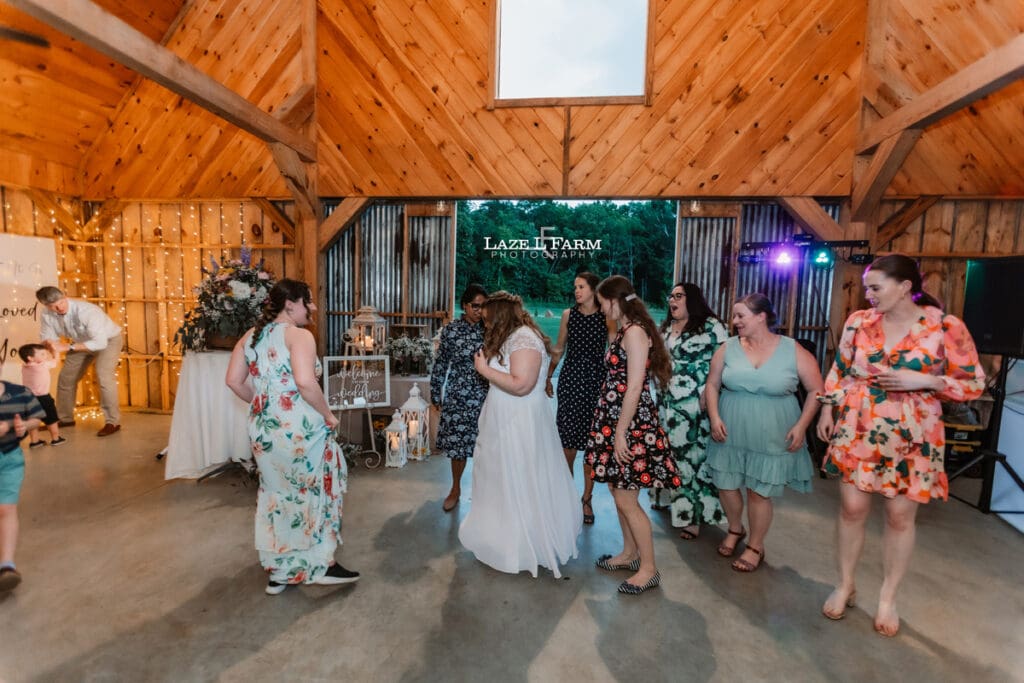 Dancing at their wedding at Woodside Farm in Graham, NC with pictures by Laze L Farm Photography