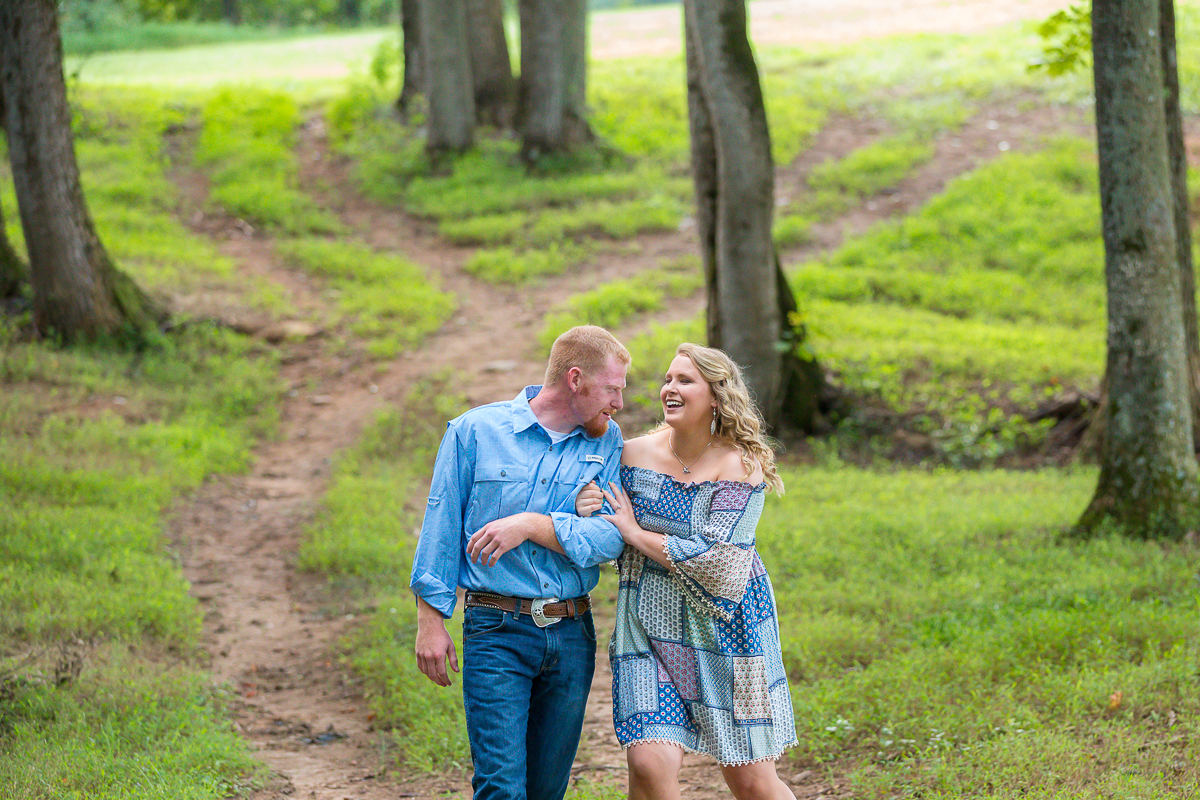Laze L Farm Photography | The Emerald Hill | couple laughing and walking through woods