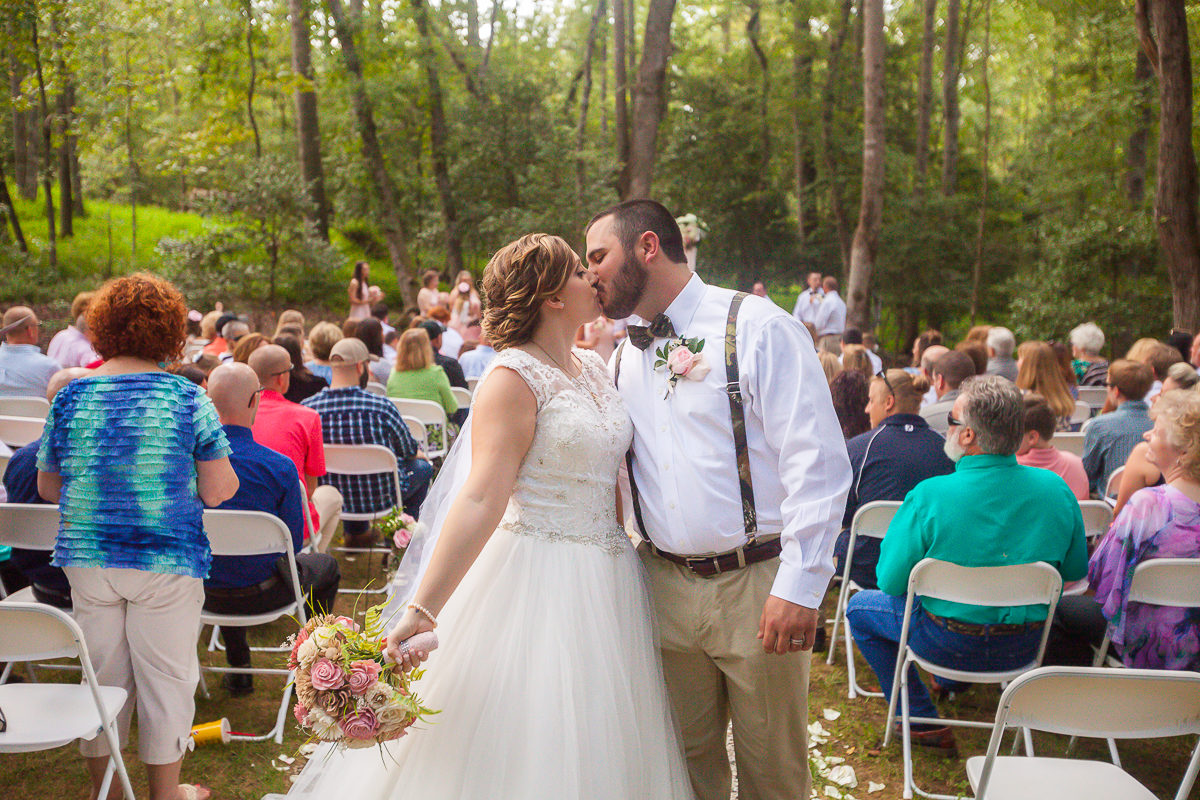 Laze L Farm Photography | Red Cedar Farms | Couple Kissing at the end of the aisle