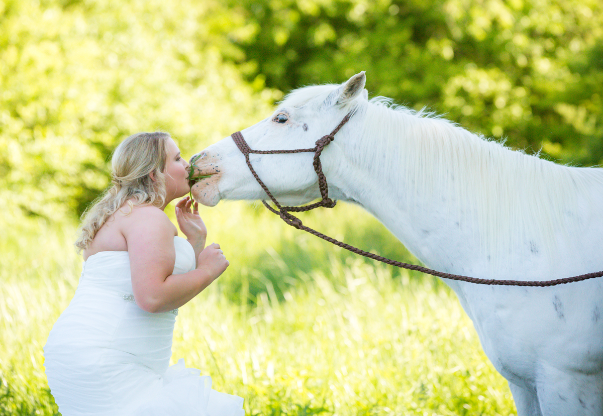 Laze L Farm Photography | Family Farm Bridal Session | Hiddenite NC | horse eating grass from brides mouth