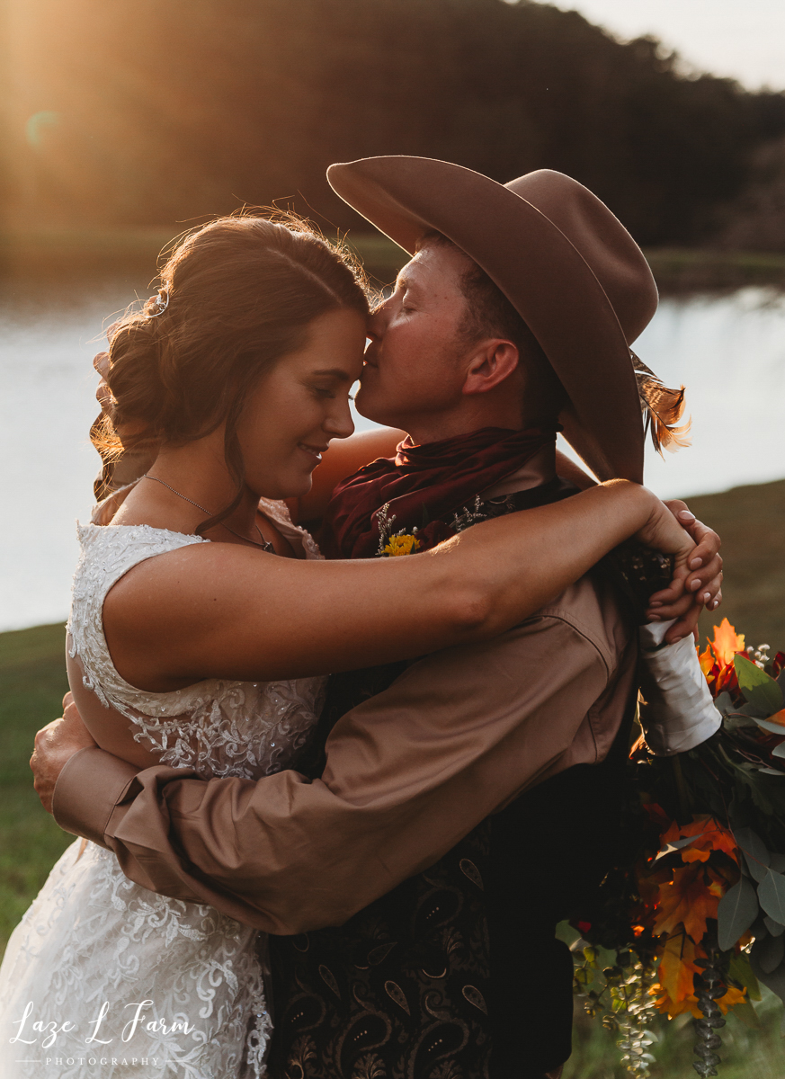 Laze L Farm Photography | Western Wedding | Johnny Wilson Farm | Sunset Bride and Groom Kisses
