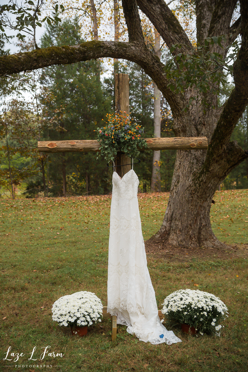 Laze L Farm Photography | Family Farm Wedding | Catawba NC | Wedding Dress Hanging on Wooden Cross