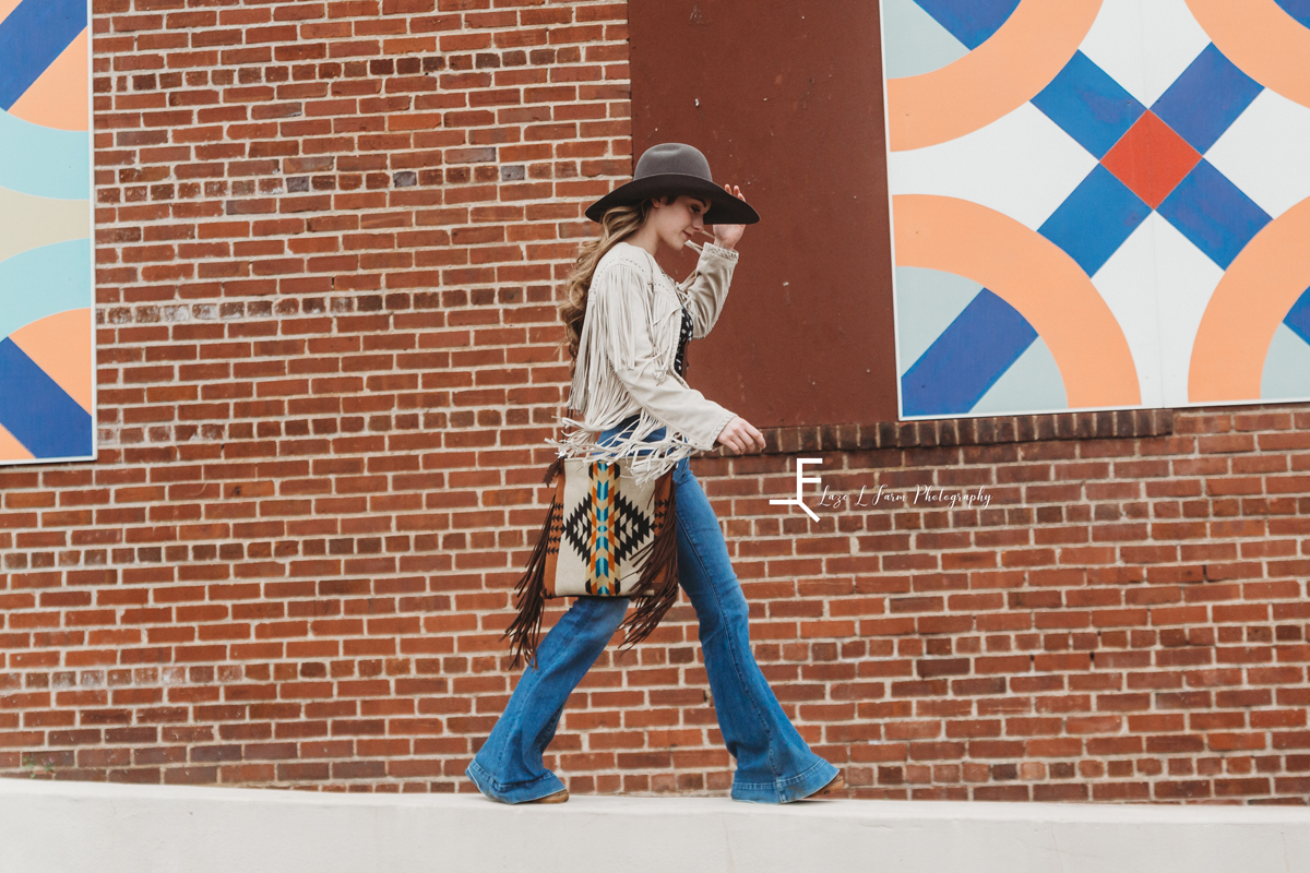Laze L Farm Photography | Mercy Grey Designs | Ashlyn | Statesville NC | a girl in a cowgirl hat carrying a mercy grey bag