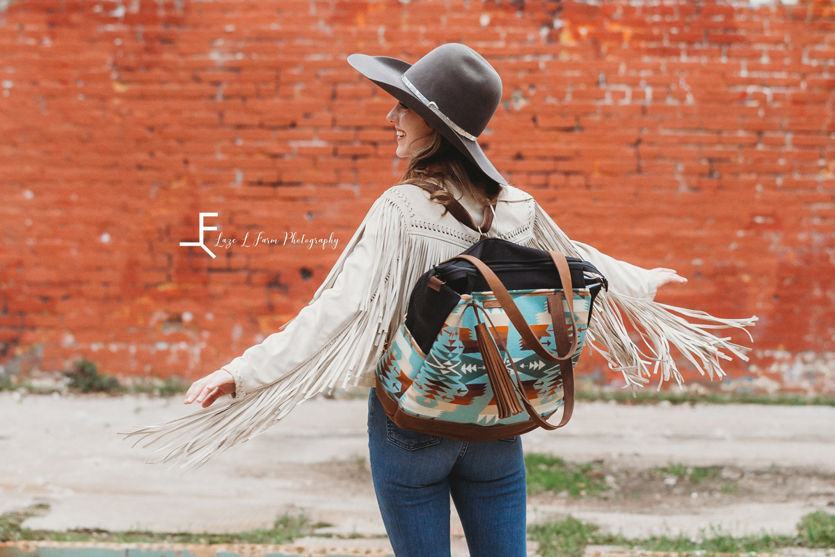 Laze L Farm Photography | Mercy Grey Designs | Ashlyn | Statesville NC | a cowgirl in a fringe jacket twirling