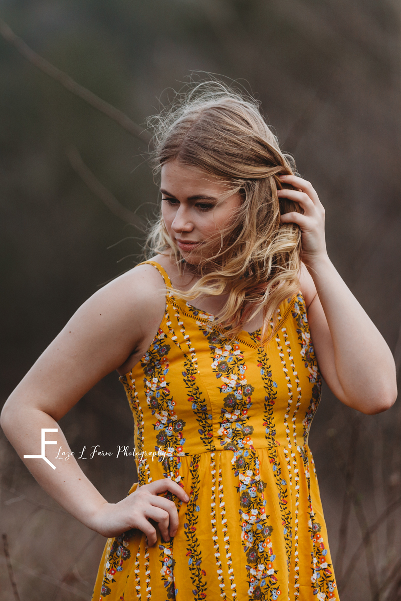 Laze L Farm Photography | Senior Session | Taylorsville NC | a girl putting her hair behind her ears