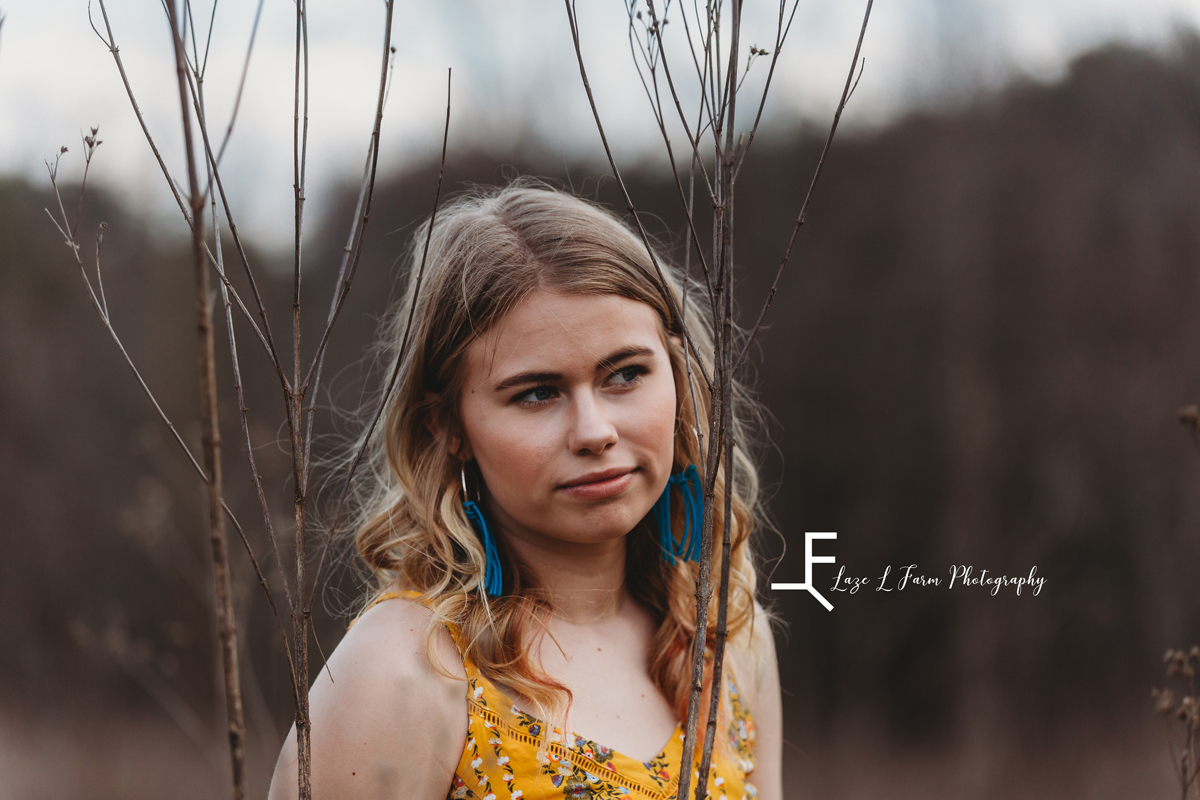 Laze L Farm Photography | Senior Session | Taylorsville NC | a senior standing in a field