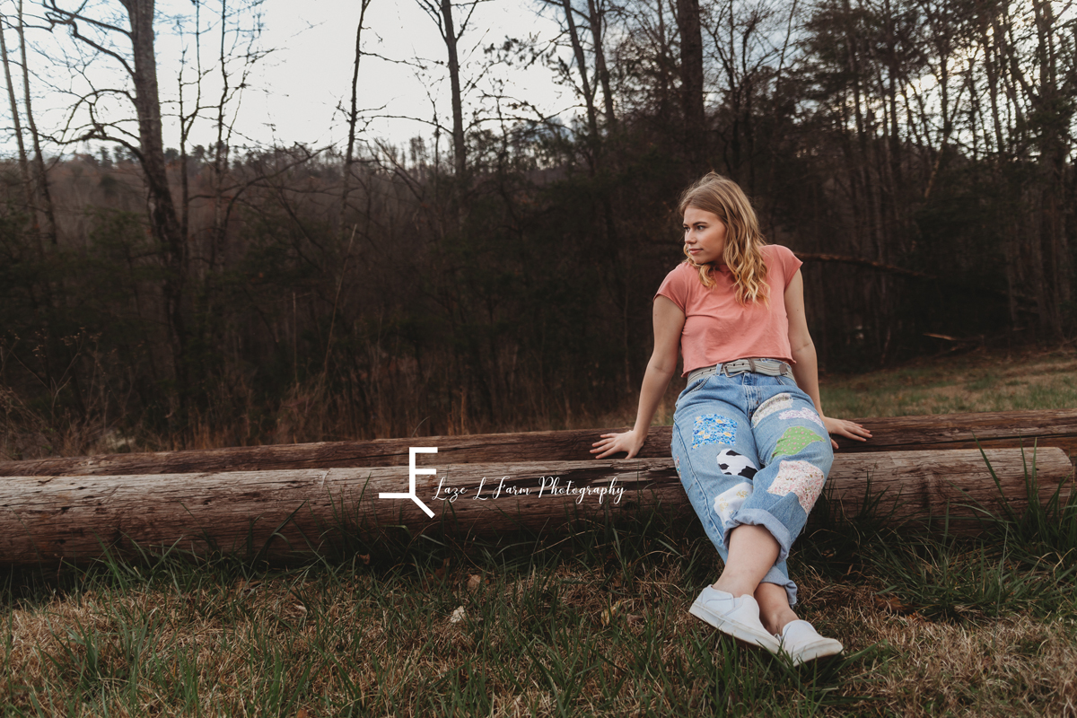 Laze L Farm Photography | Senior Session | Taylorsville NC | a girl sitting on a log in a field