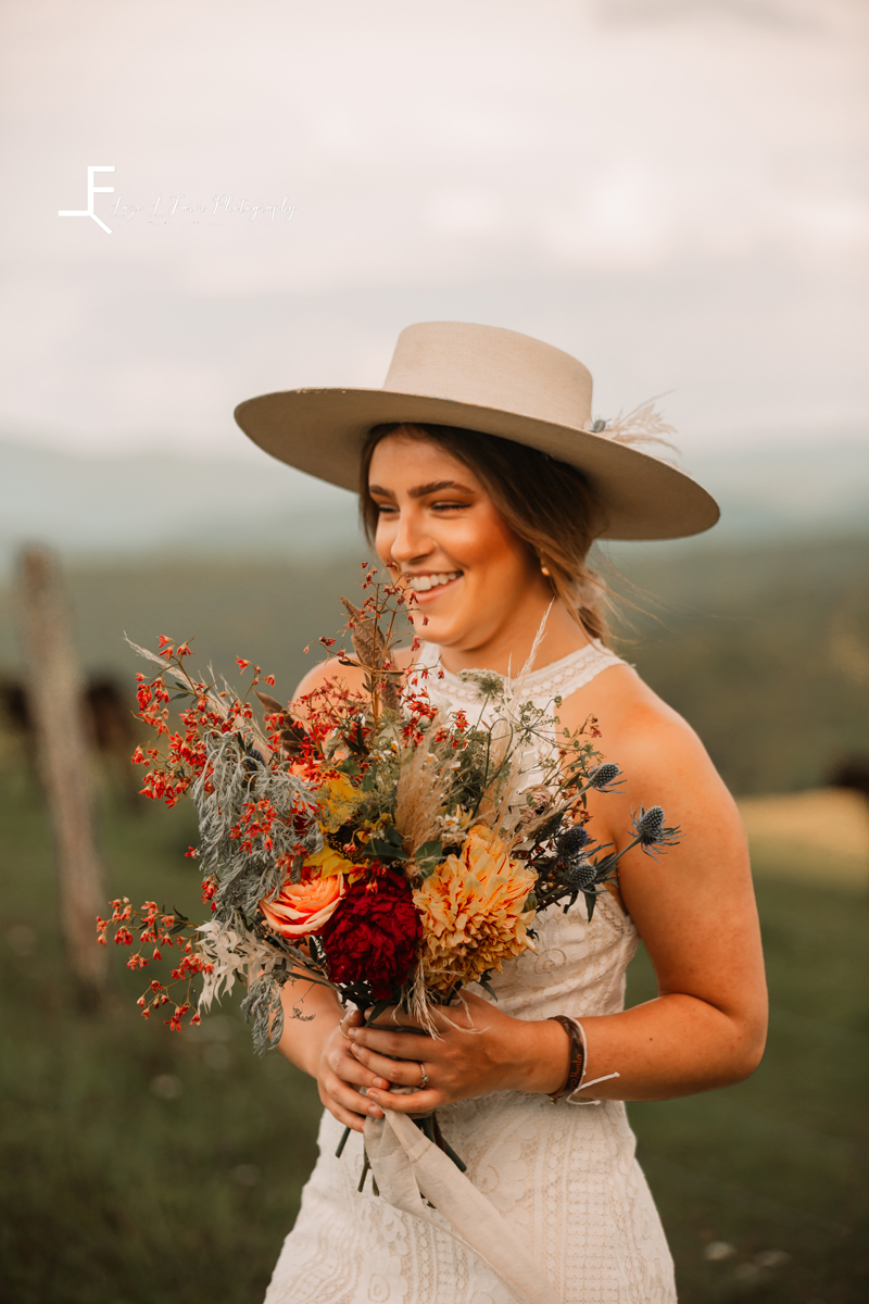 Laze L Farm Photography | The White Crow | Wedding Venue | Banner Elk NC | Close up smiling with bouquet