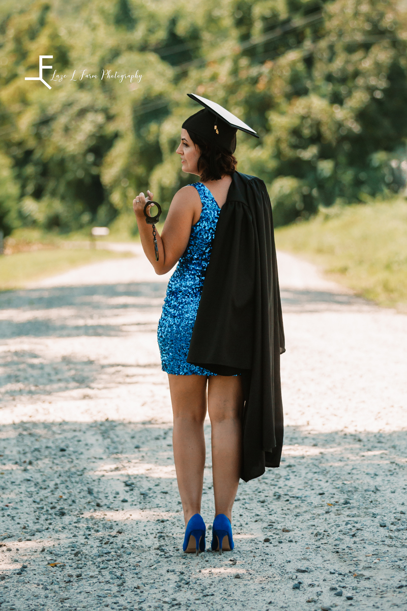 Laze L Farm Photography | Graduation Photography | Taylorsville NC | Holding the gown and badge