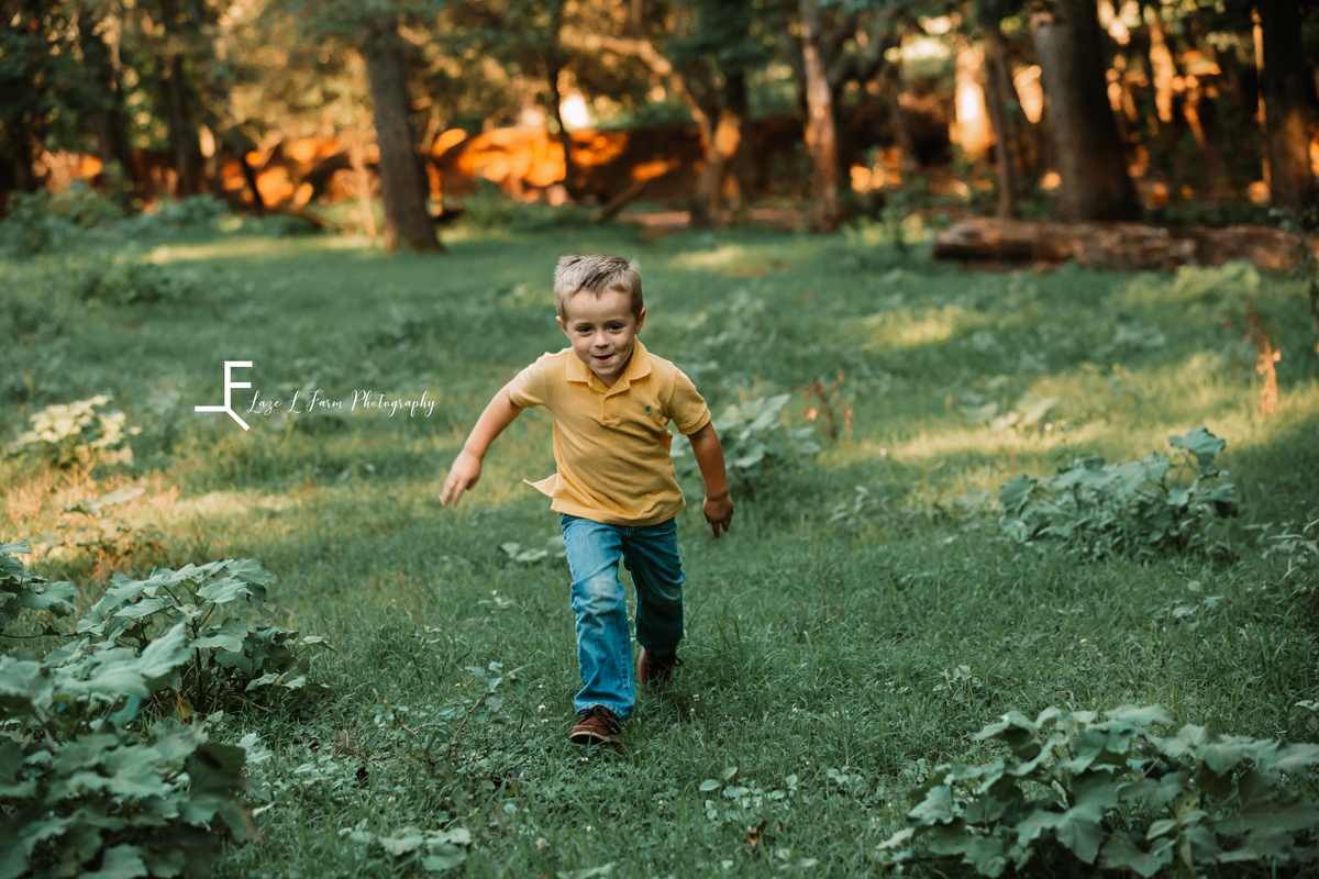 Laze L Farm Photography | Farm Session | Taylorsville NC | a little boy running in a field