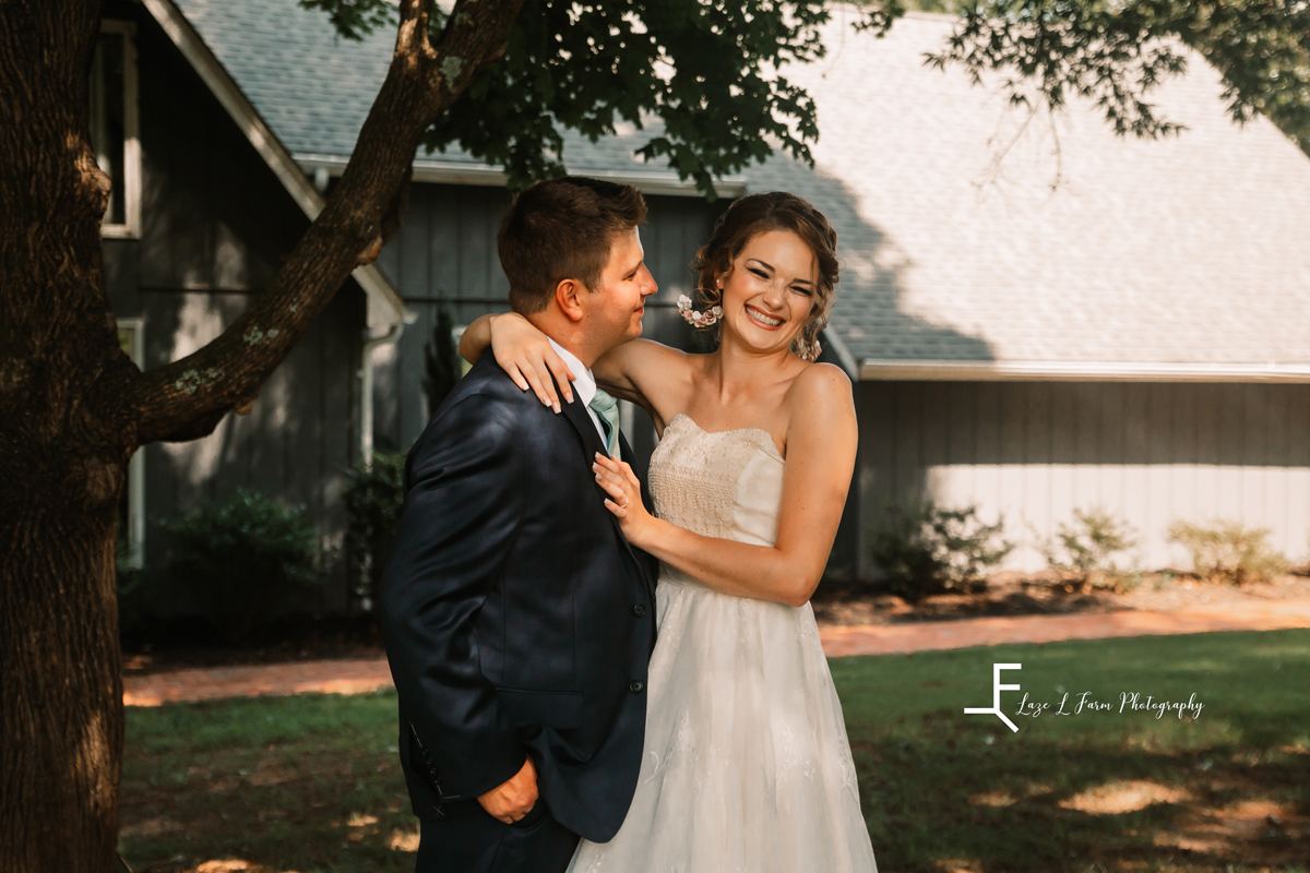Laze L Farm Photography | Wedding Photography | Hickory NC | Bride smiling holding on to groom