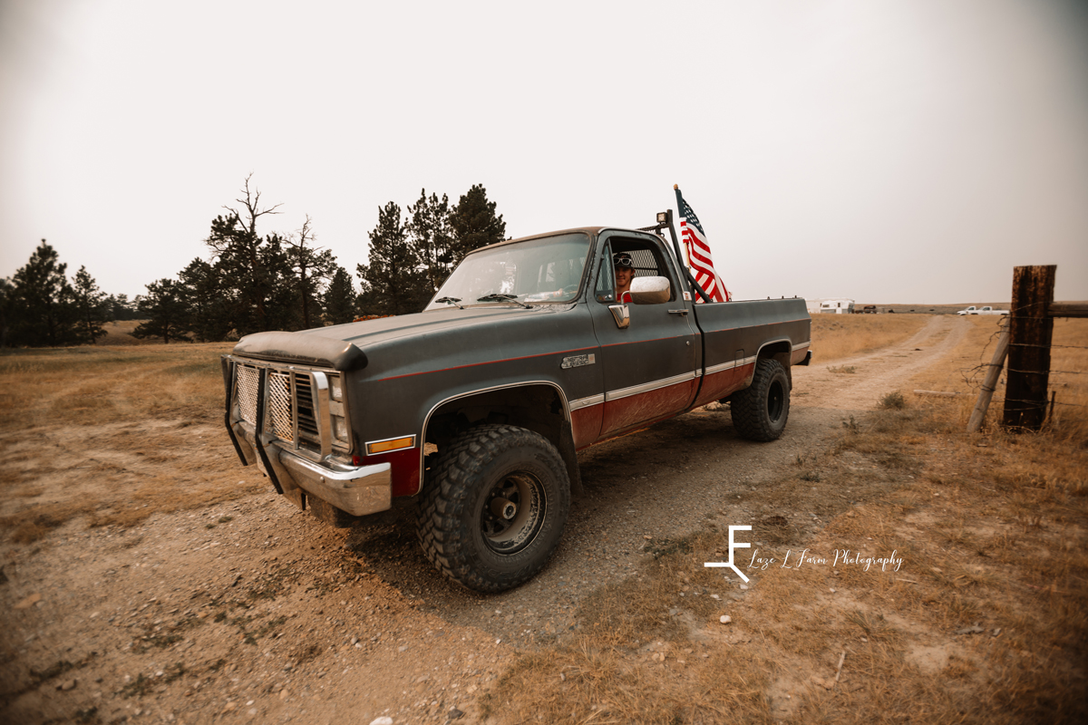 Laze L Farm Photography | Billings Montana | Shot of Will driving truck with flag