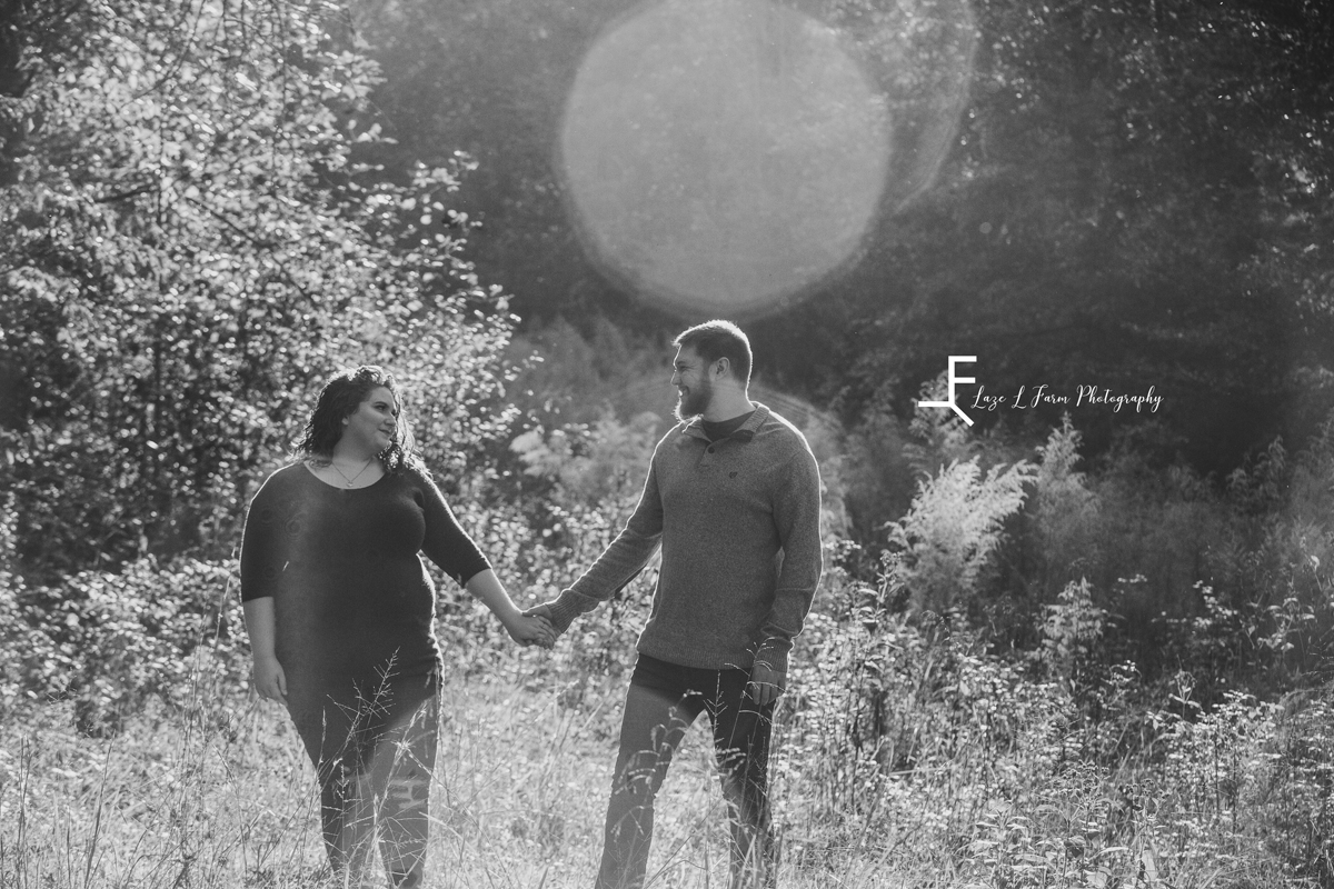 Laze L Farm Photography | Engagement Photography | Taylorsville NC | black and white walking in the field holding hands