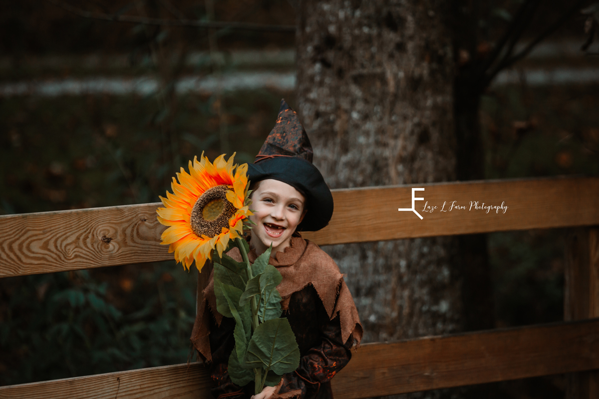 Laze L Farm Photography | Farm Session | Taylorsville NC | smiling with sunflower 