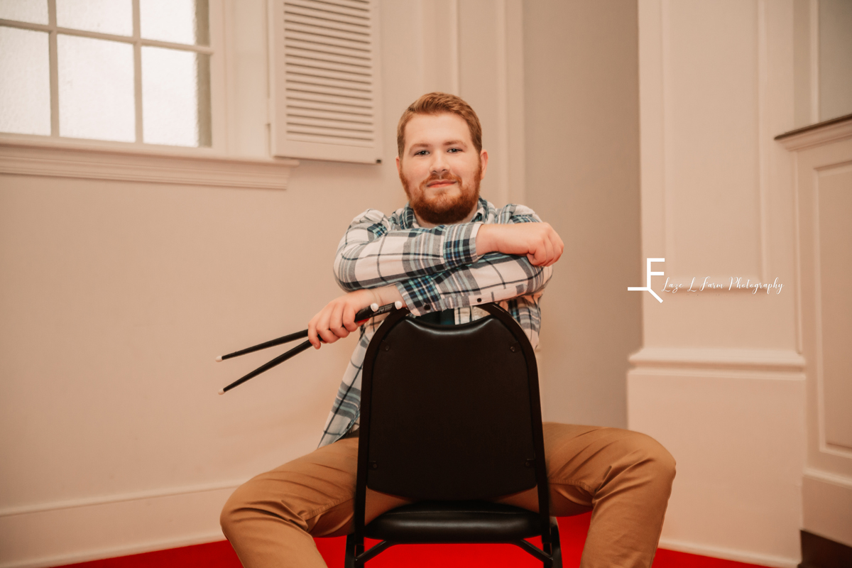 Laze L Farm Photography | Senior Pictures | Taylorsville NC | posing with the drum sticks and a chair 
