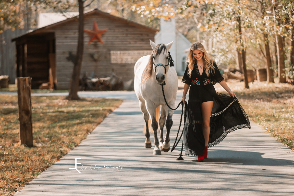 Laze L Farm Photography | Senior Photography | Equine Photography | walking her horse in the dress