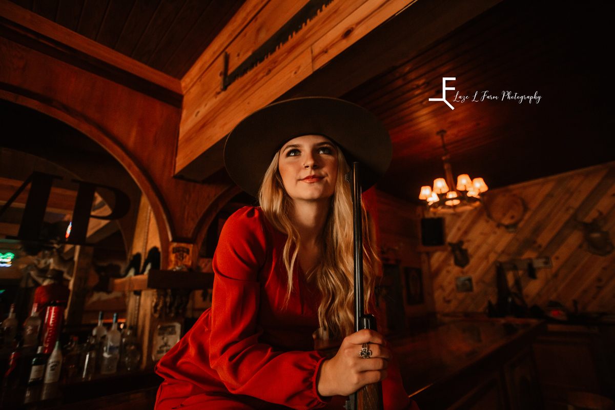 Laze L Farm Photography | Senior Photography | Equine Photography | posing inside with the gun