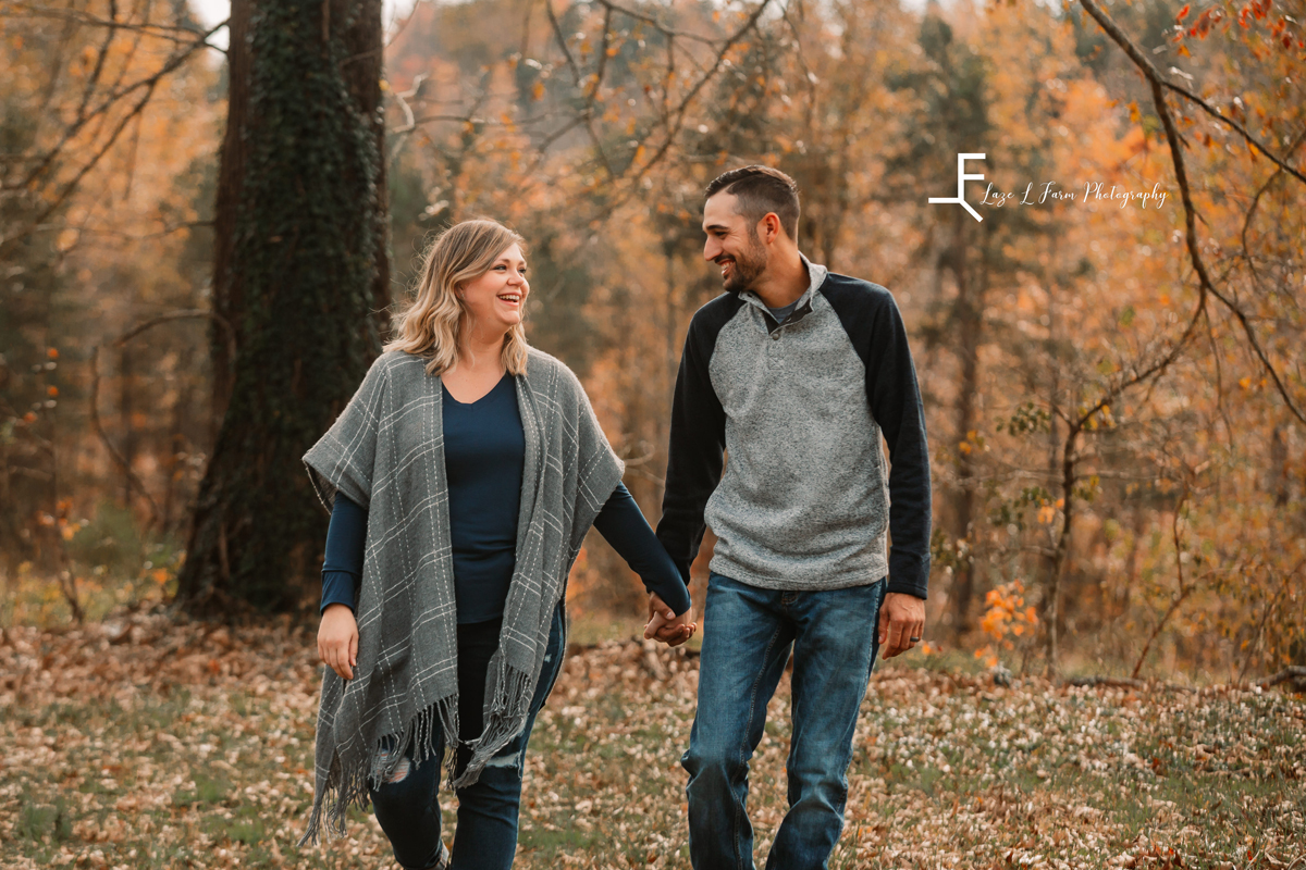 Laze L Farm Photography | Farm Session | Taylorsville NC | candid of couple walking holding hands