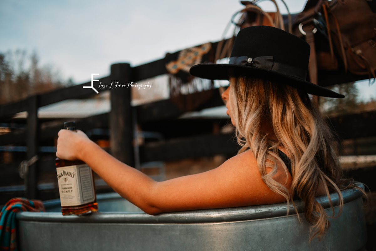Laze L Farm Photography | Beth dutton | Water Trough | Taylorsville NC | holding the whiskey bottle