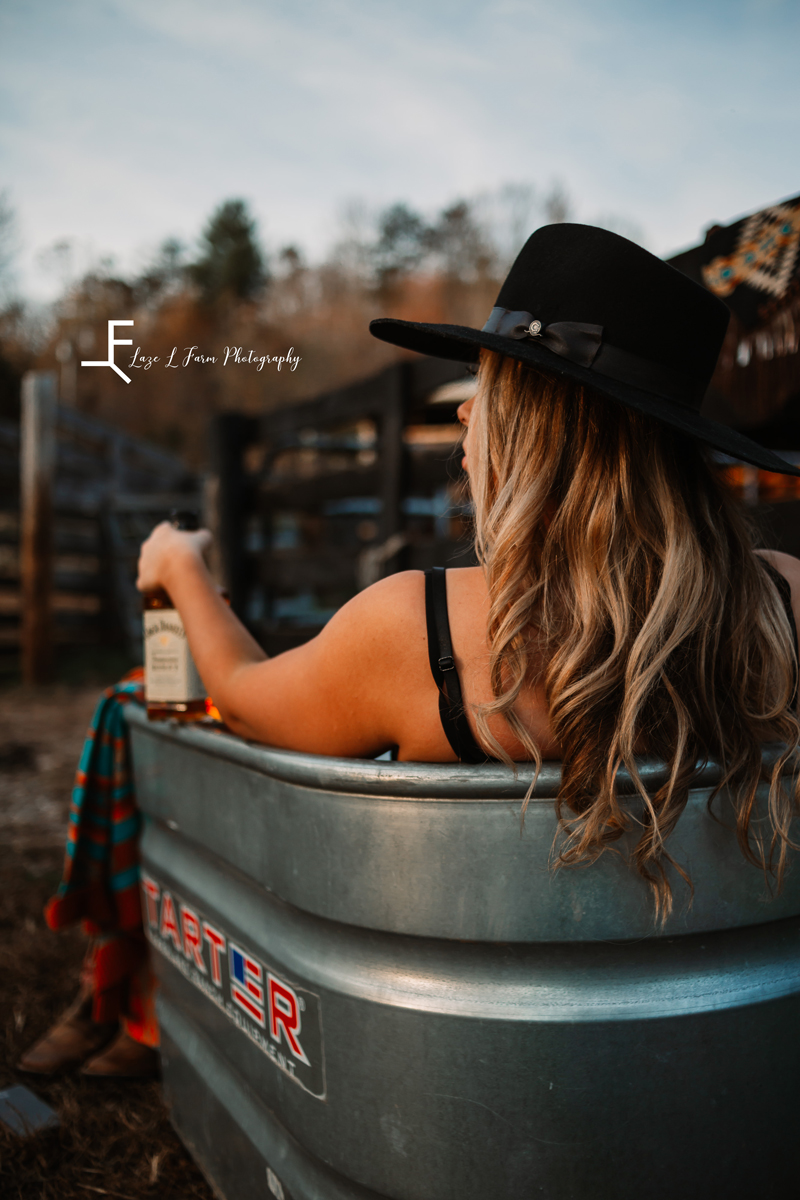 Laze L Farm Photography | Beth dutton | Water Trough | Taylorsville NC | shooting behind rebekah holding the whiskey