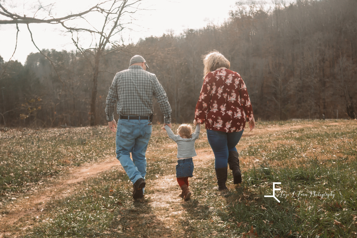 Laze L Farm Photography | Farm Session | Taylorsville NC | family walking away holding hands with daughter
