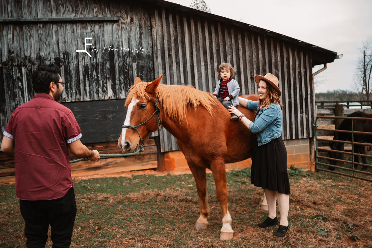 Laze L Farm Photography | Farm Session | Taylorsville NC | parents helping elias ride horse