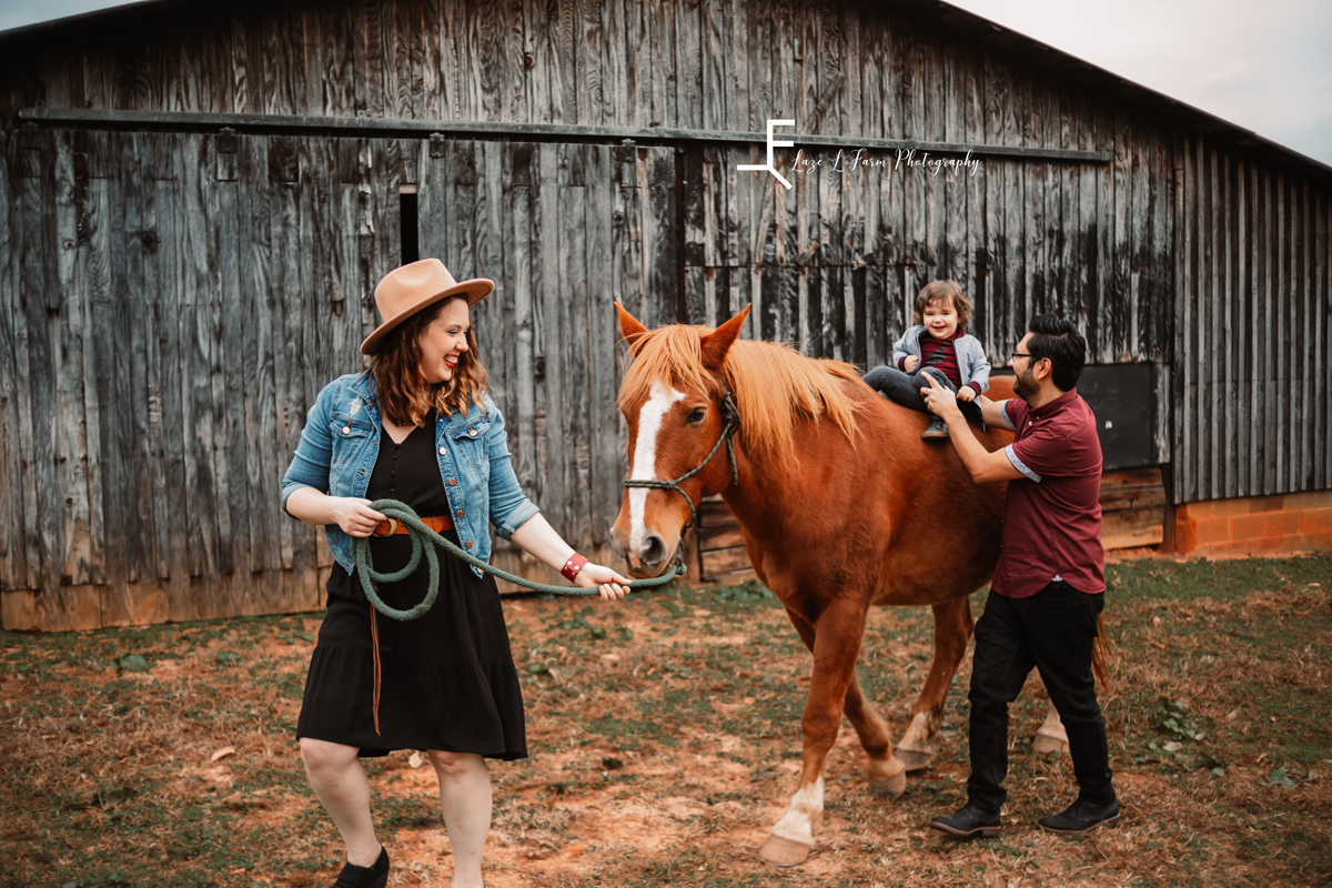 Laze L Farm Photography | Farm Session | Taylorsville NC | mom and dad walking the horse with elias