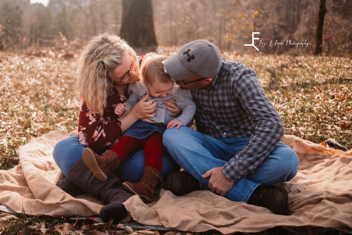Laze L Farm Photography | Farm Session | Taylorsville NC | sitting parents kissing daughter