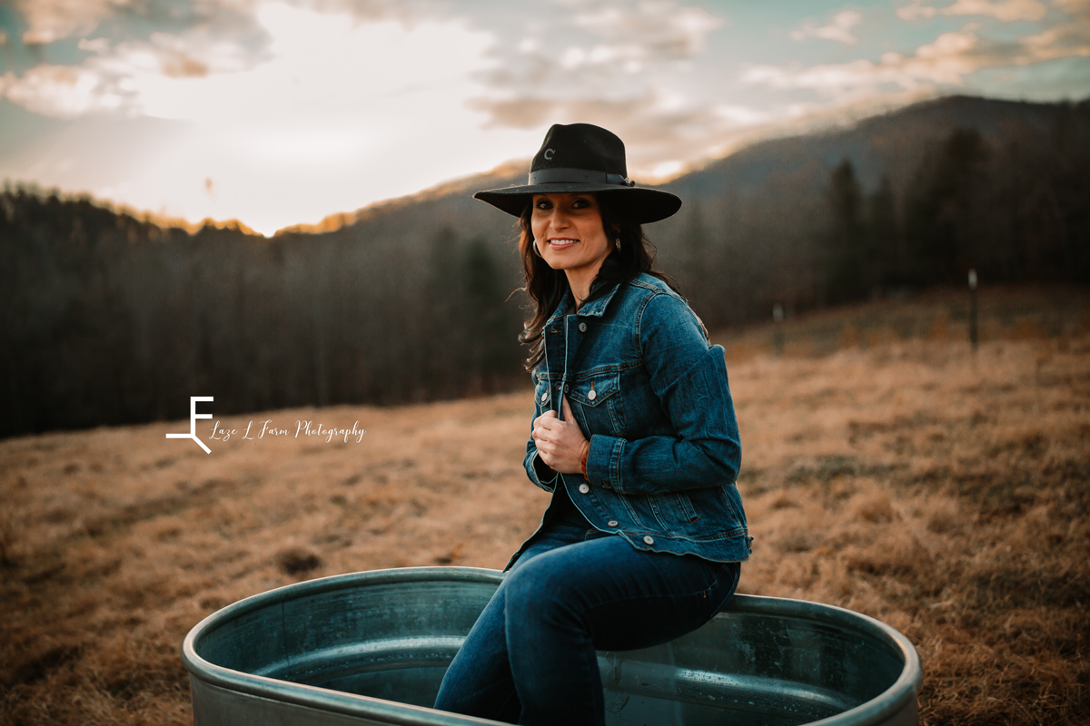 Laze L Farm Photography | Western Lifestyle | Taylorsville NC | wearing jean jacket and sitting on trough in the field 