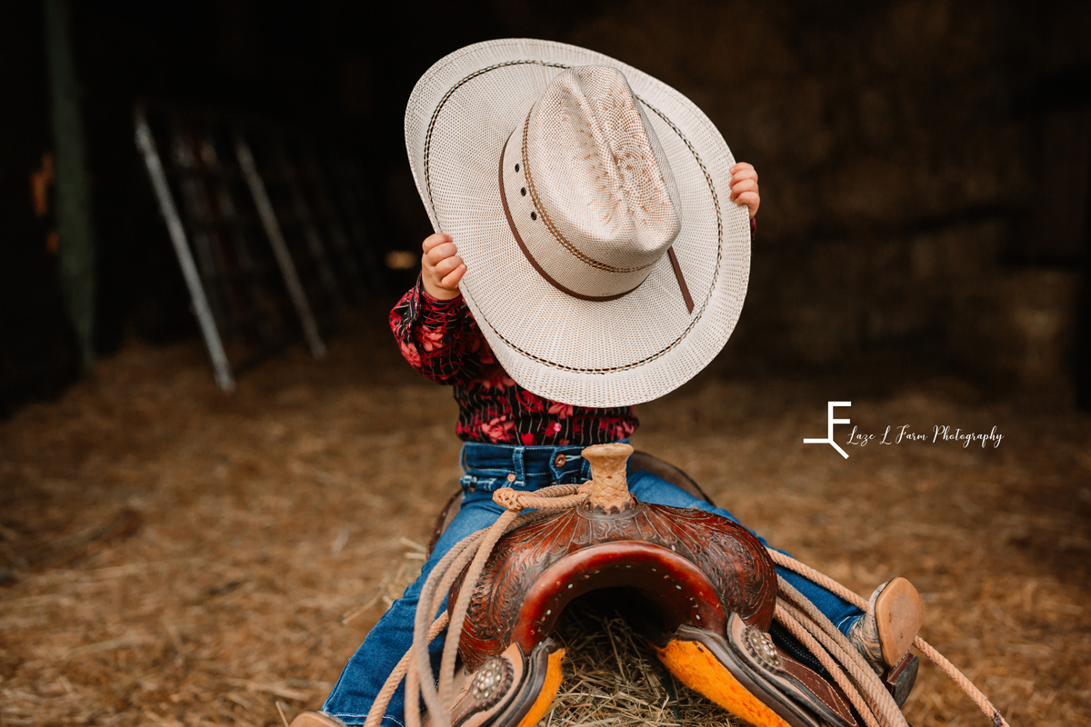  Laze L Farm Photography | Farm Session | Taylorsville NC | hat blocking her face on the saddle