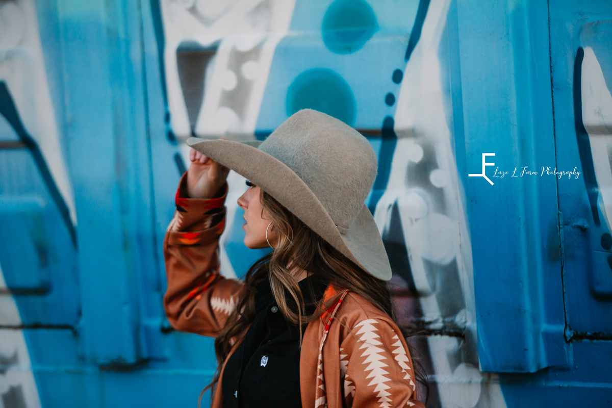 Laze L Farm Photography | Western Lifestyle | Elkin NC | tipping her hat in front of the blue wall