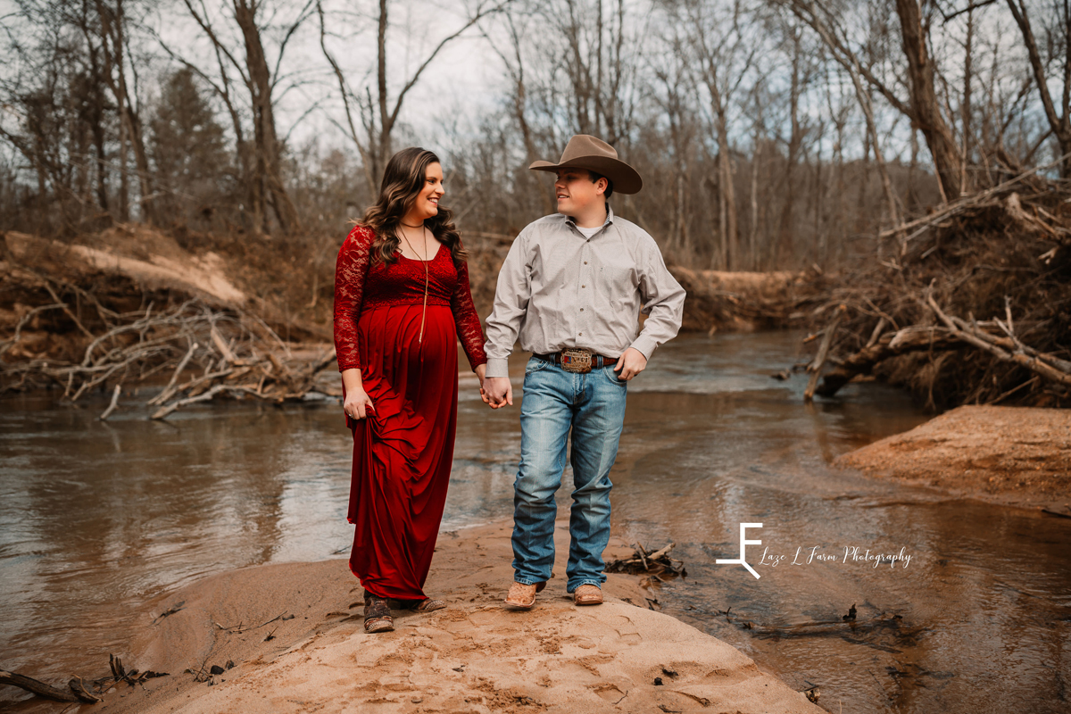 Laze L Farm Photography | Equine Maternity Session | Bethlehem NC | couple candid looking at each other