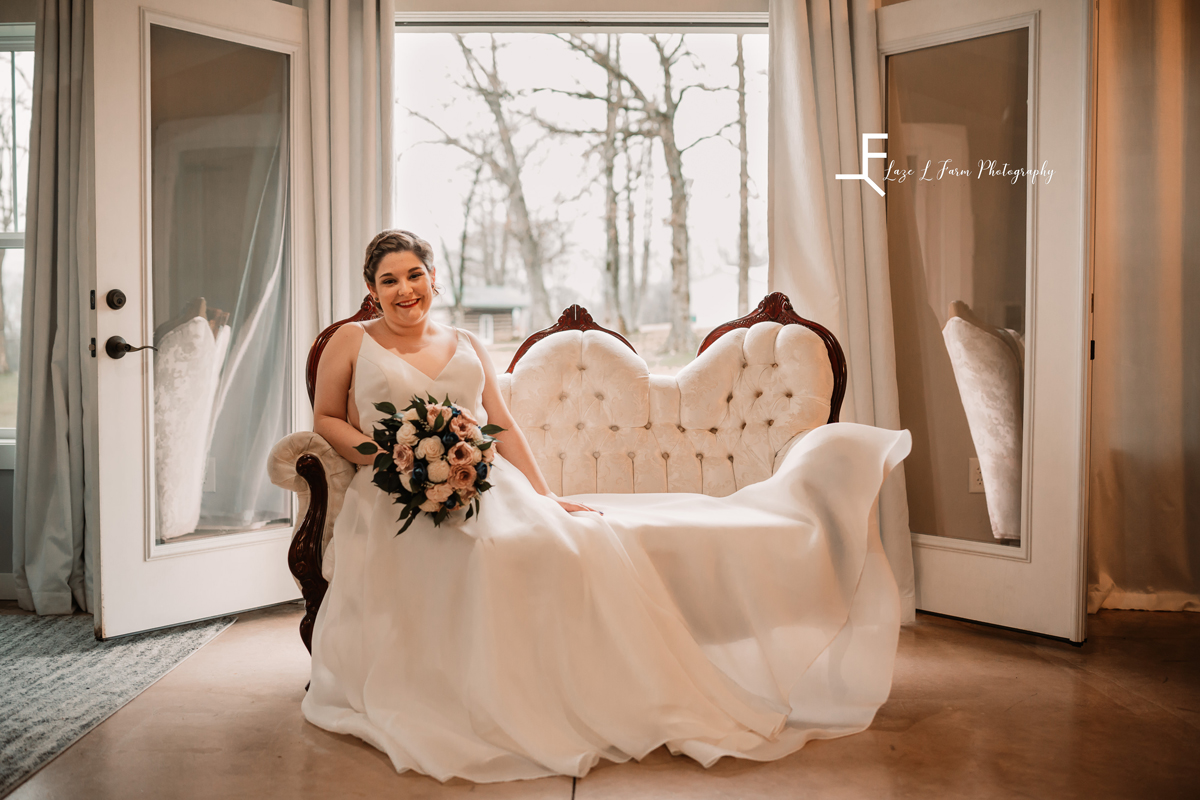 Laze L Farm Photography | Bridal Session | The Emerald Hill | posed of bride sitting on loveseat with bouquet