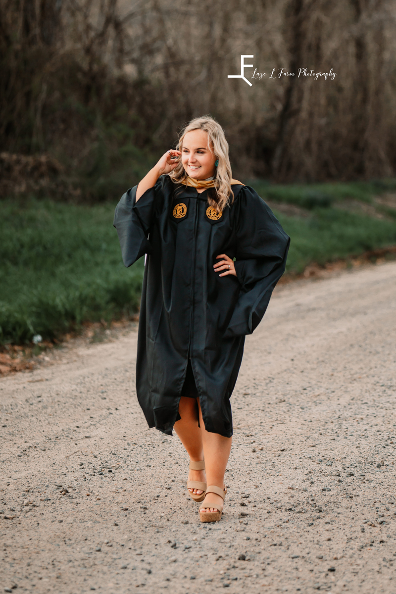 Laze L Farm Photography | College Graduation Pictures | Taylorsville NC | candid walking down the road in graduation gown