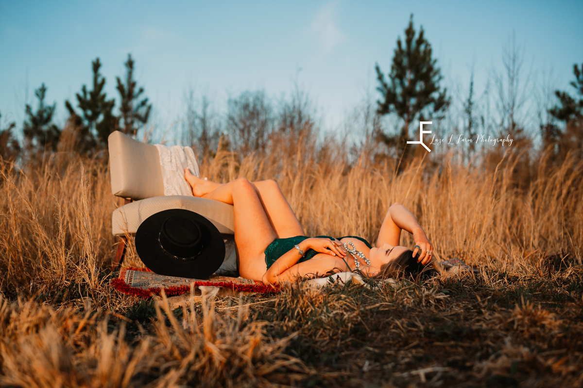 Laze L Farm Photography | Cowgirl Boudoir | Statesville NC | laying down with legs on the chair