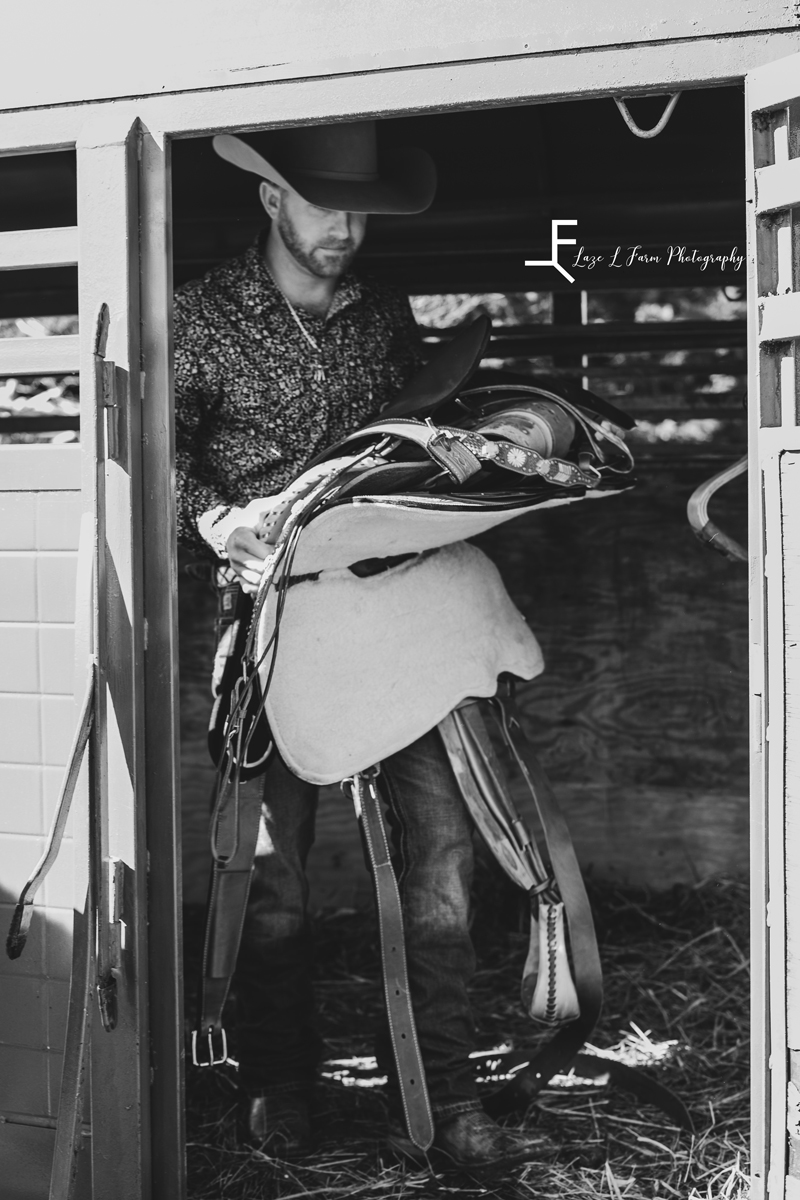 Laze L Farm Photography | Western Lifestyle | Lenoir NC | cowboy carrying saddle