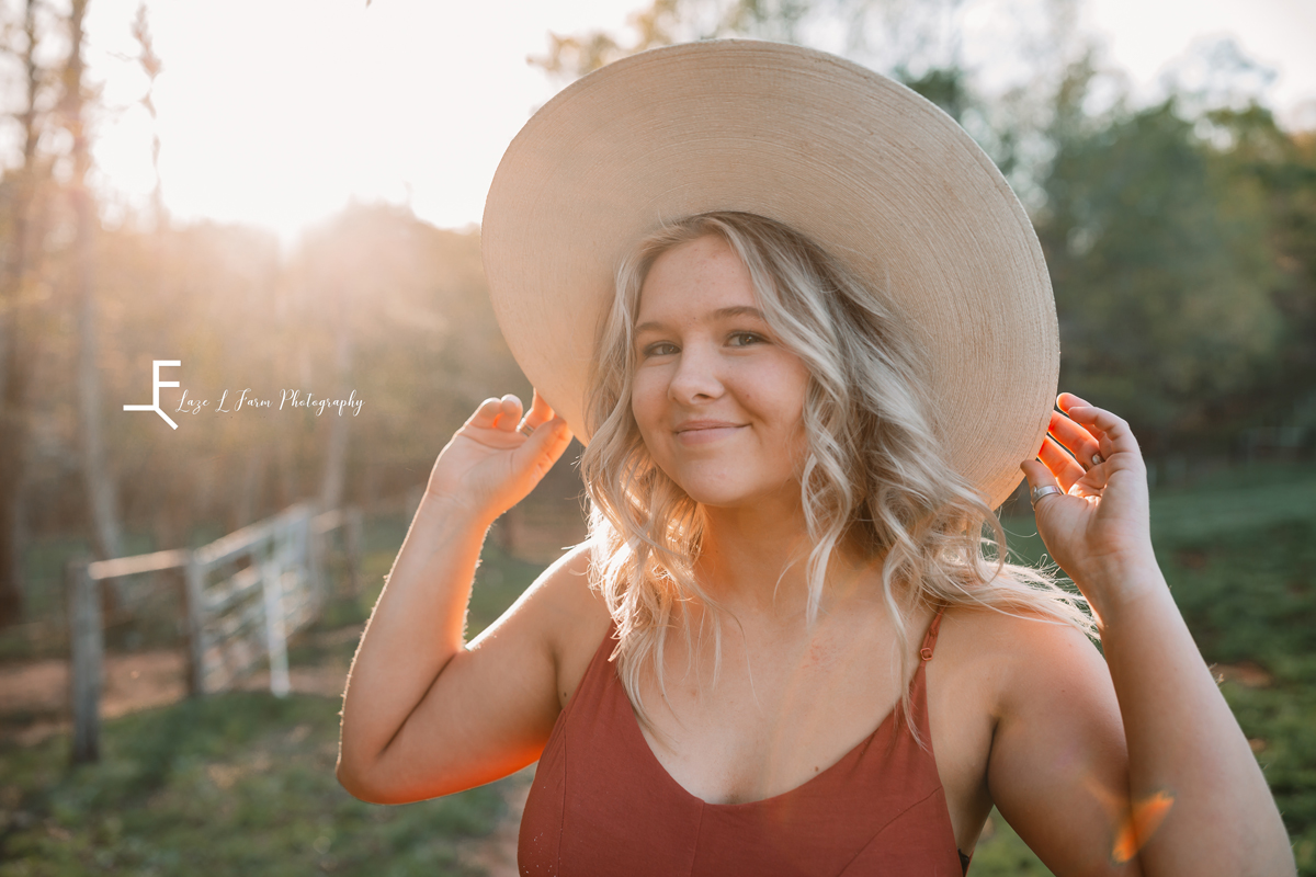 Laze L Farm Photography |Senior Pictures | Taylorsville NC | smiling holding onto her hat