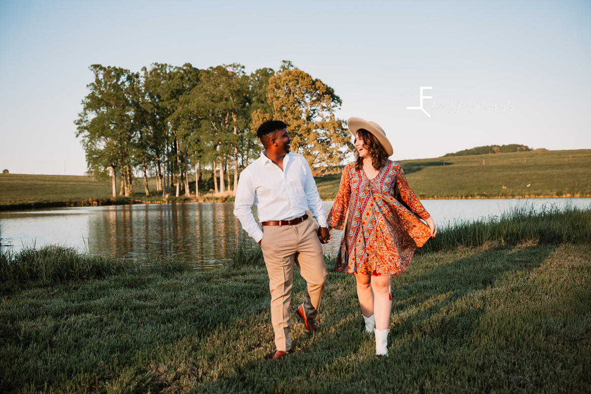Laze L Farm Photography | Engagement Session | The Emerald Hill - Hiddenite NC | walking by the pond holding hands