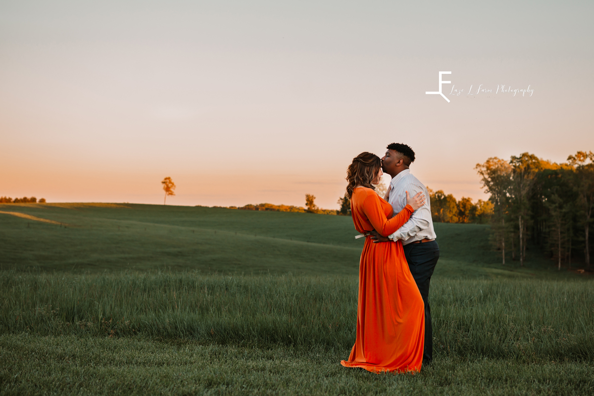 Laze L Farm Photography | Engagement Session | The Emerald Hill - Hiddenite NC | embracing in the field during sunset