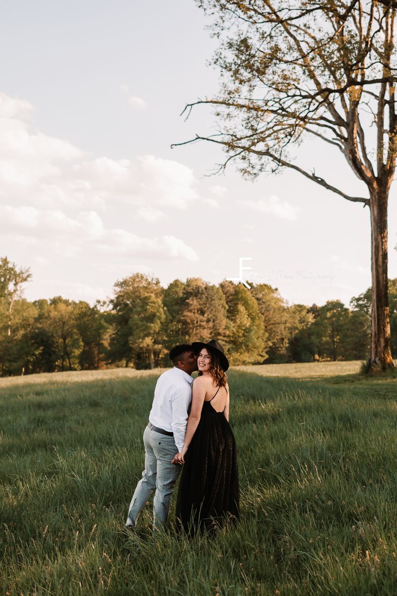 Laze L Farm Photography | Engagement Session | The Emerald Hill - Hiddenite NC | posing in the field looking back