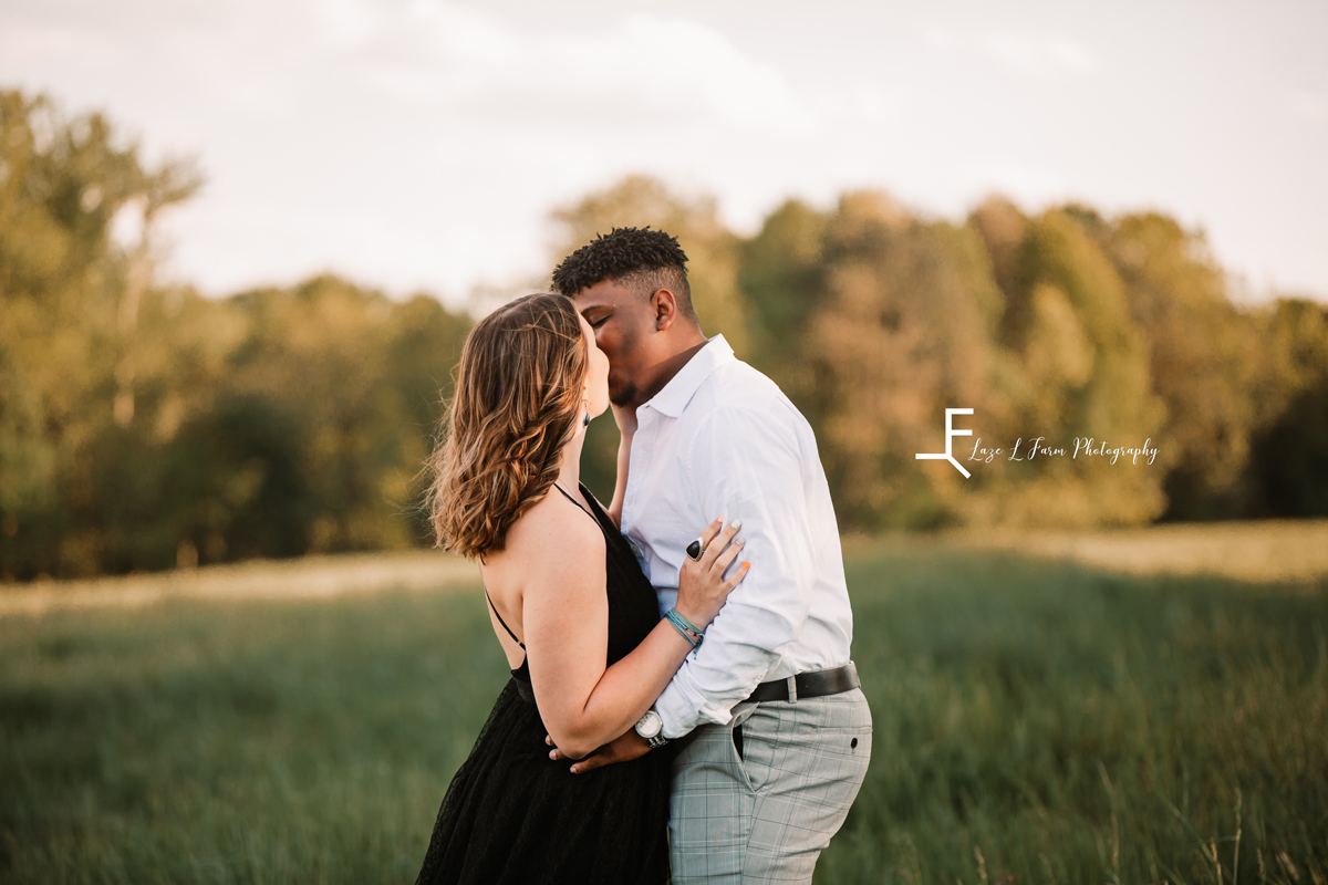 Laze L Farm Photography | Engagement Session | The Emerald Hill - Hiddenite NC | kissing in the field