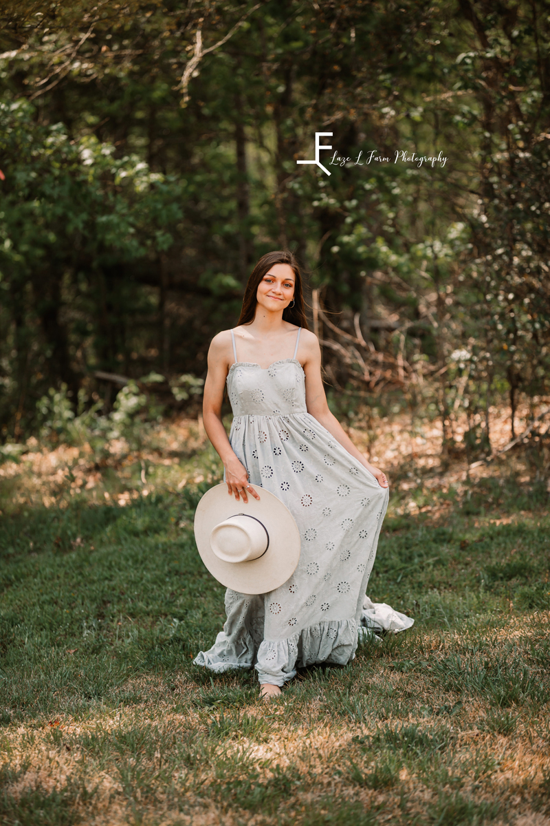 Laze L Farm Photography | Fairytale Dress Photoshoot | Taylorsville NC | holding her hat and twirling her dress